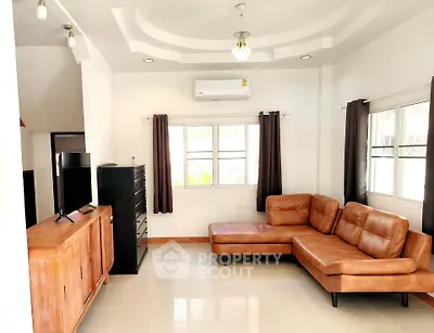 Spacious living room with modern leather sectional sofa and sleek entertainment unit.