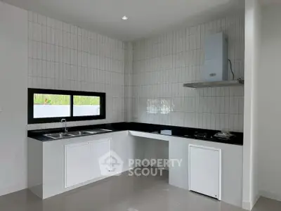 Modern kitchen with sleek black countertops and white cabinetry
