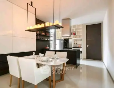 Modern kitchen with dining area, sleek design and elegant lighting