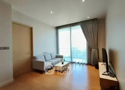 Modern living room with large window and stylish furniture in a bright apartment.