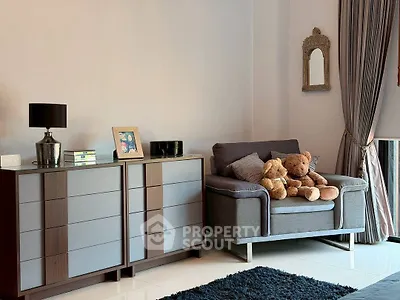 Cozy living room with modern furniture and plush teddy bears, perfect for relaxation.