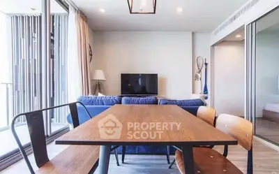 Modern living room with stylish dining area and large windows