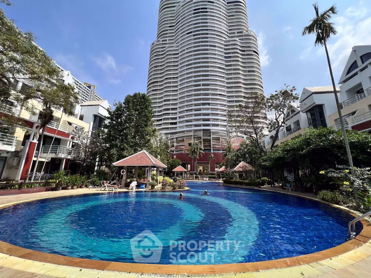 Luxurious residential building with stunning pool and lush garden view