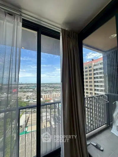 Stunning high-rise balcony view with cityscape and clear blue skies.