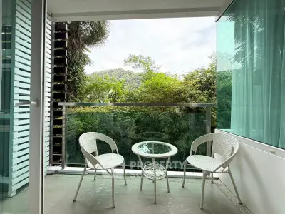 Charming balcony with lush green view, perfect for relaxation and enjoying nature.