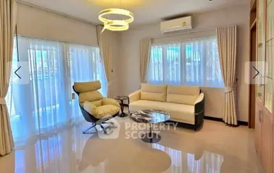 Modern living room with elegant furniture and large windows