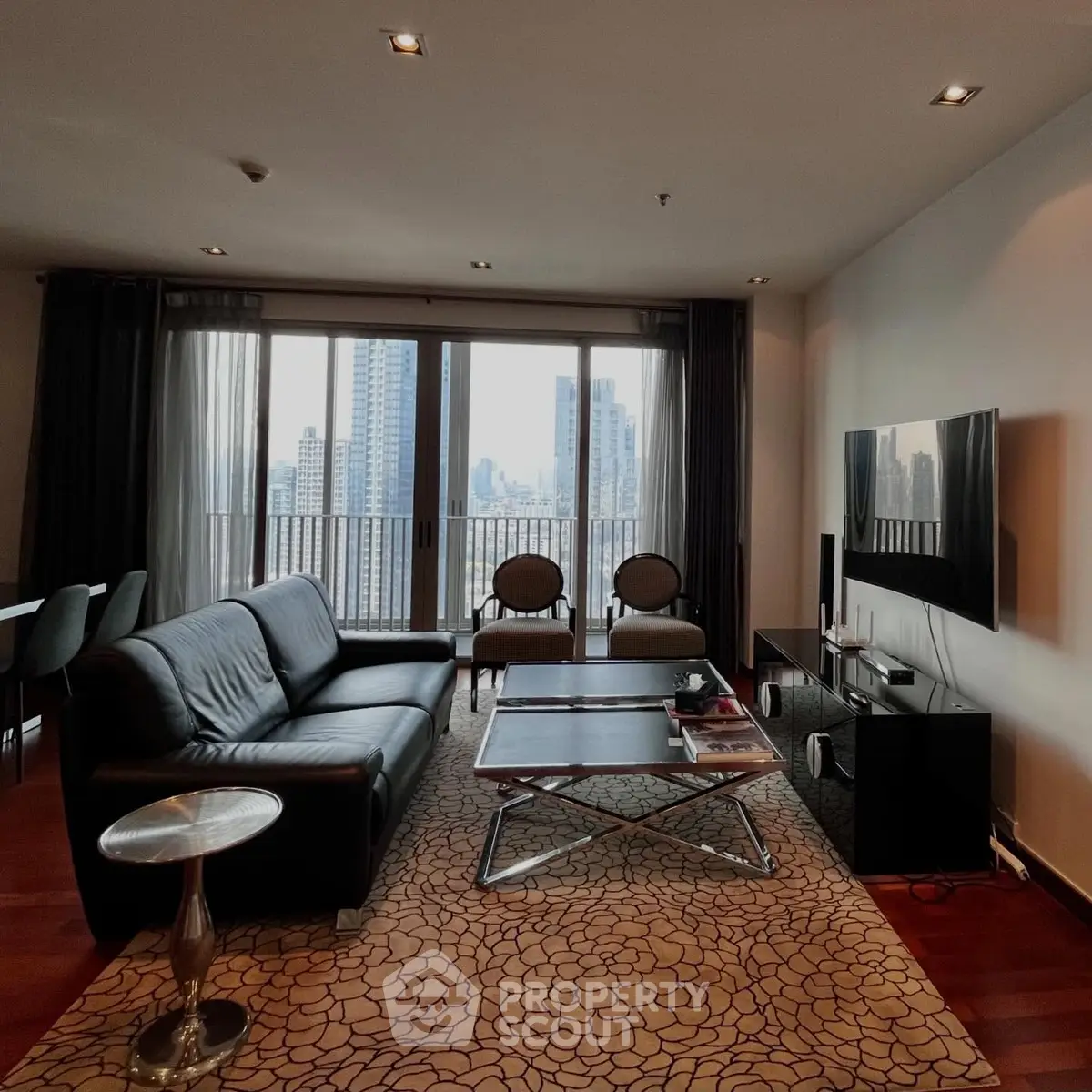 Luxurious living room with stunning city view, modern furniture, and elegant decor in high-rise apartment.