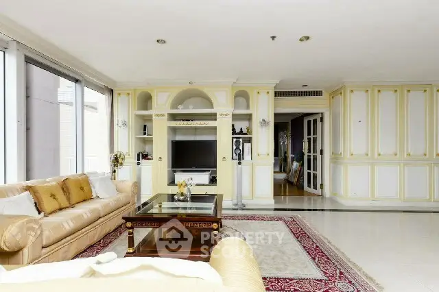 Luxurious living room with elegant decor and spacious layout, featuring plush sofas and a stylish entertainment center.