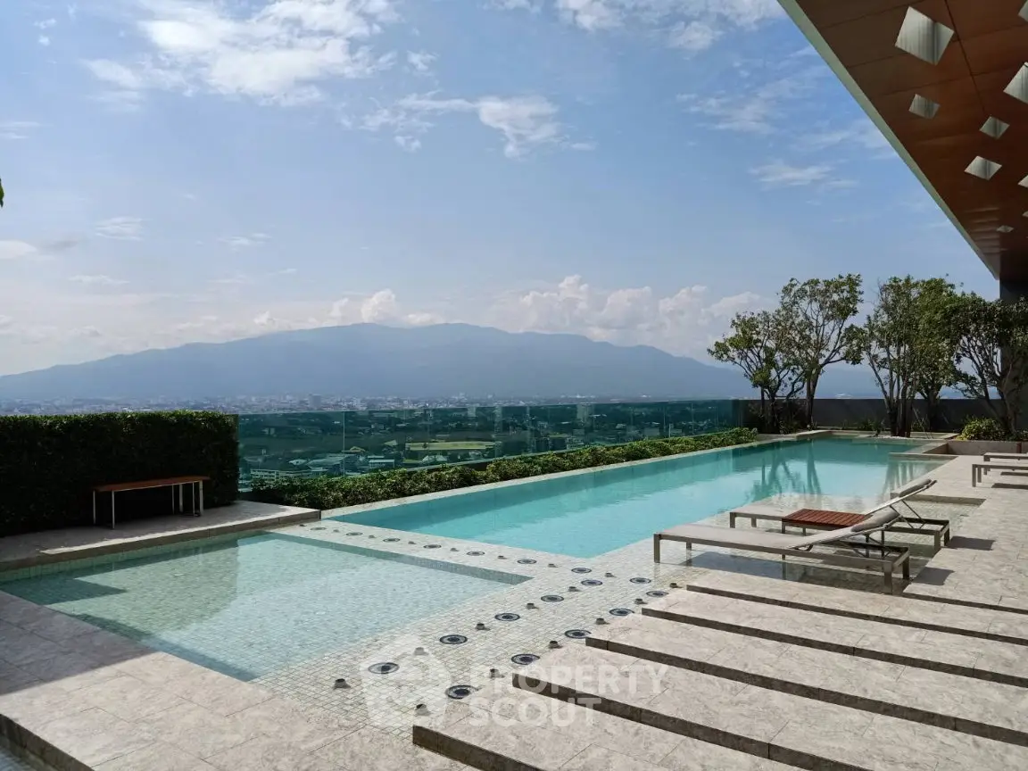 Luxurious rooftop pool with stunning mountain views and modern lounge chairs.