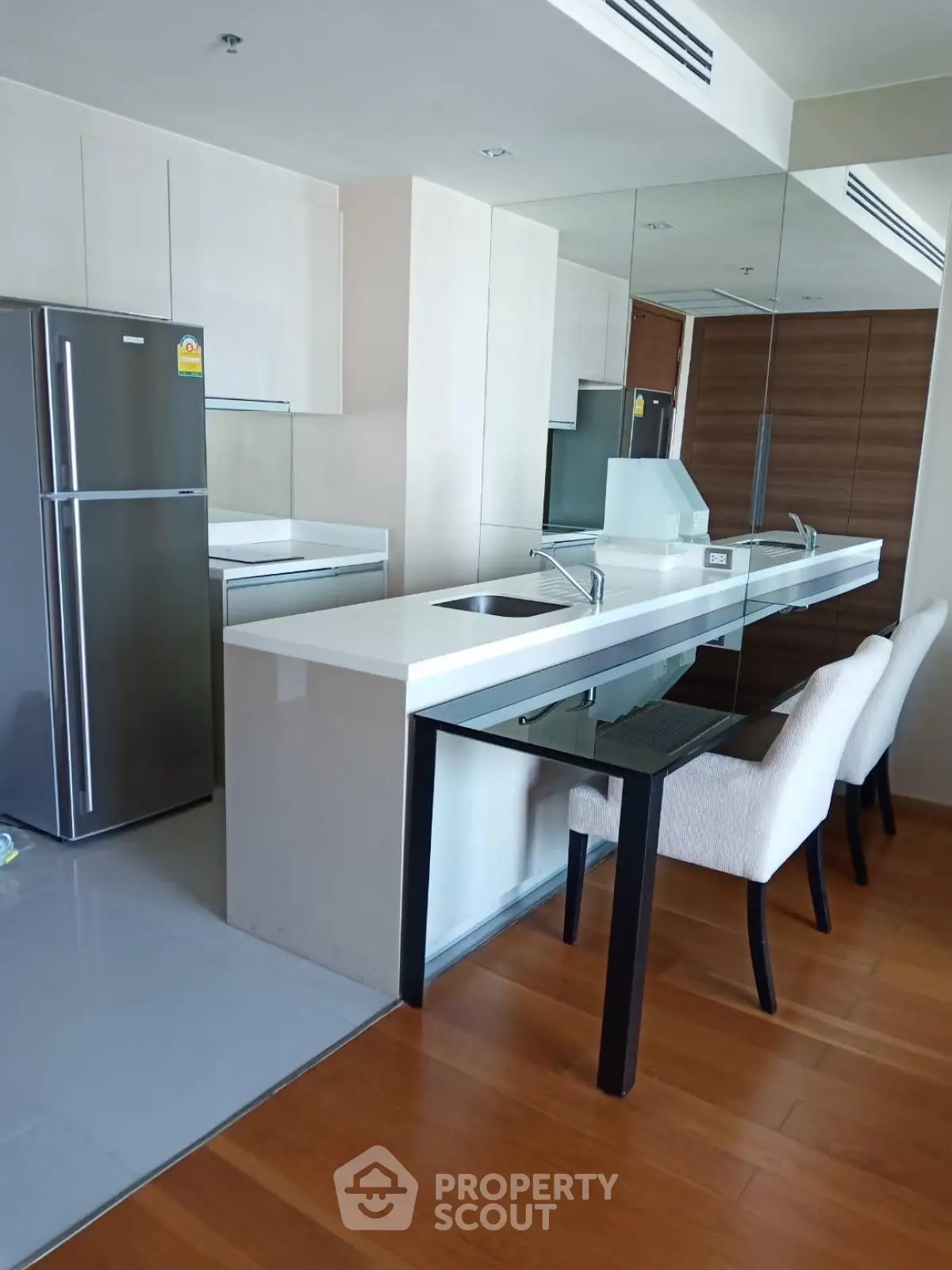 Modern kitchen with sleek design and integrated dining area in upscale apartment