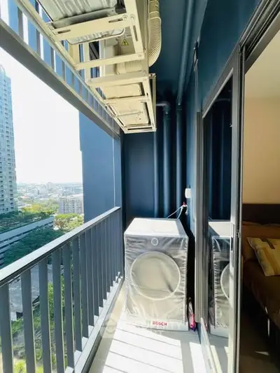 Modern balcony with city view and Bosch washing machine, perfect for urban living.