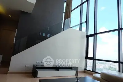 Modern living room with floor-to-ceiling windows and city view