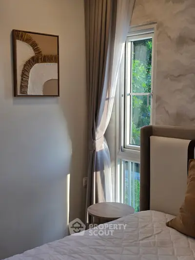 Cozy bedroom with elegant decor and natural light through window