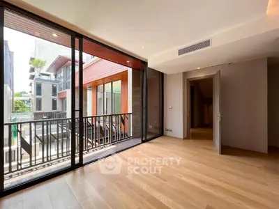 Spacious modern living room with large windows and balcony view in luxury apartment