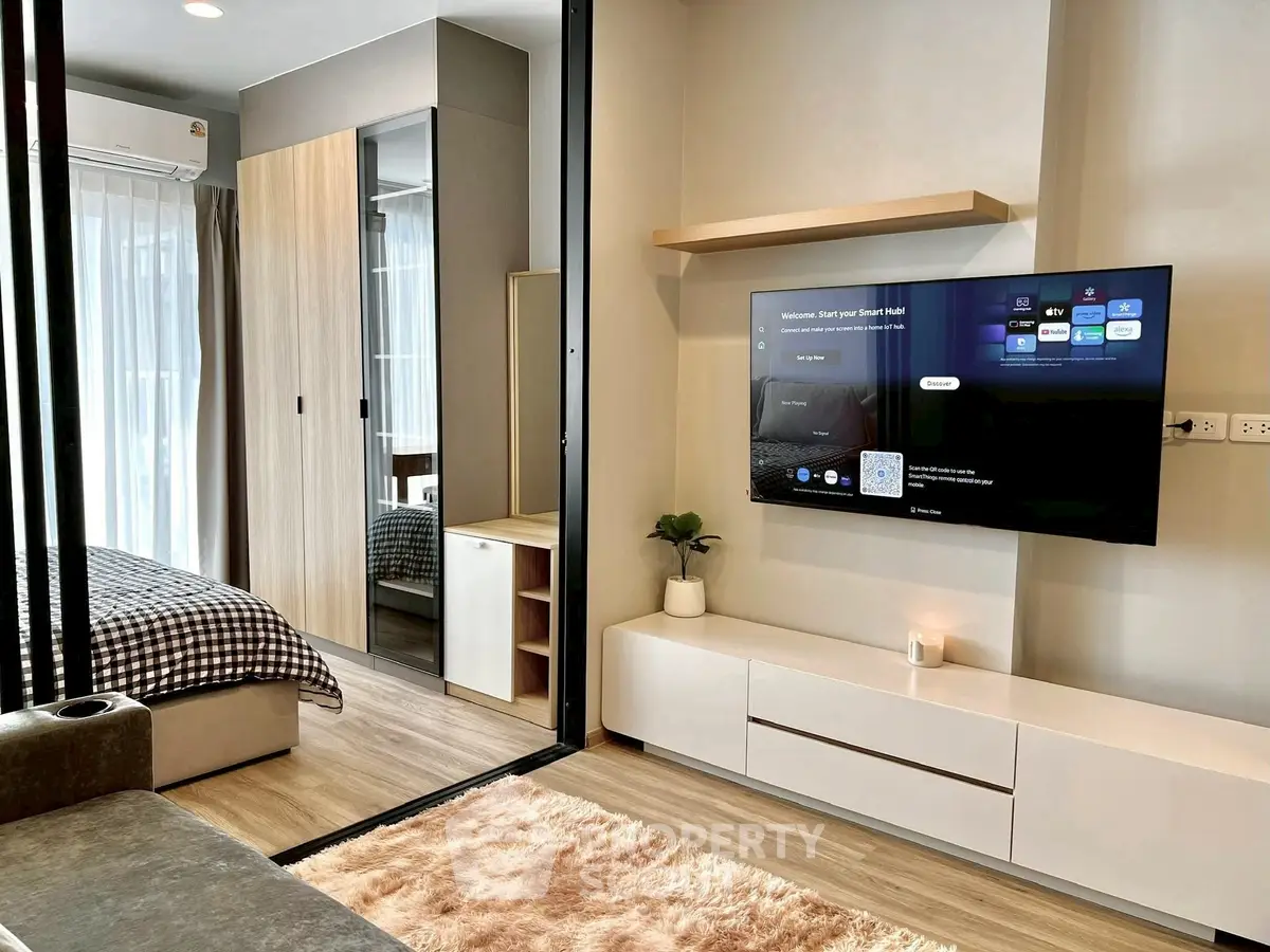 Modern studio apartment with stylish living area and cozy bedroom