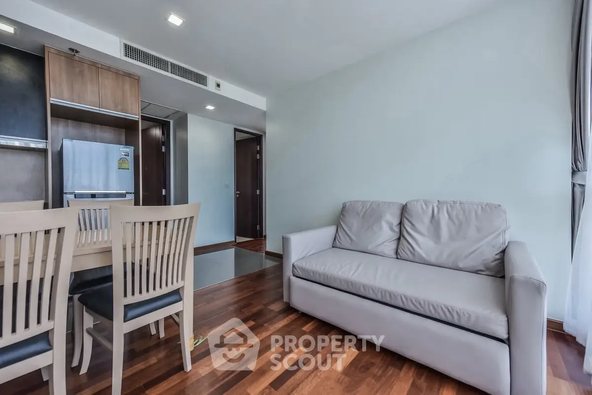 Modern living room with wooden flooring and stylish furniture in a contemporary apartment.
