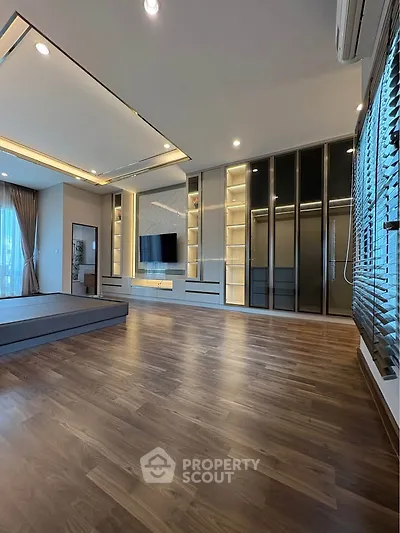 Spacious modern living room with elegant wooden flooring and built-in storage