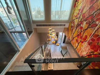 Luxurious modern living room with high ceilings and artistic wall mural