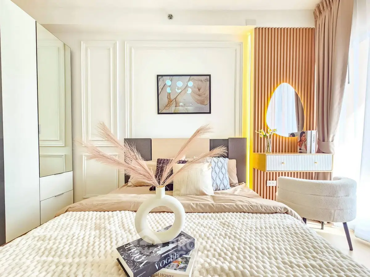 Luxurious bedroom with elegant decor and natural light, featuring modern furniture and stylish accents.