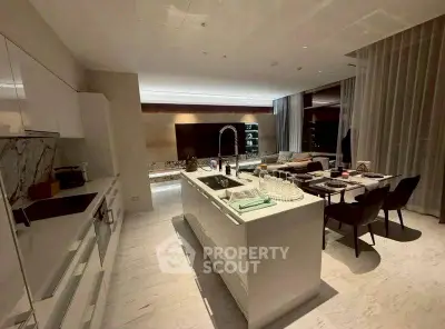 Luxurious open-layout kitchen with modern island and elegant dining area