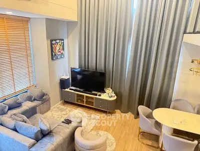 Modern living room with stylish furniture and large windows for natural light.
