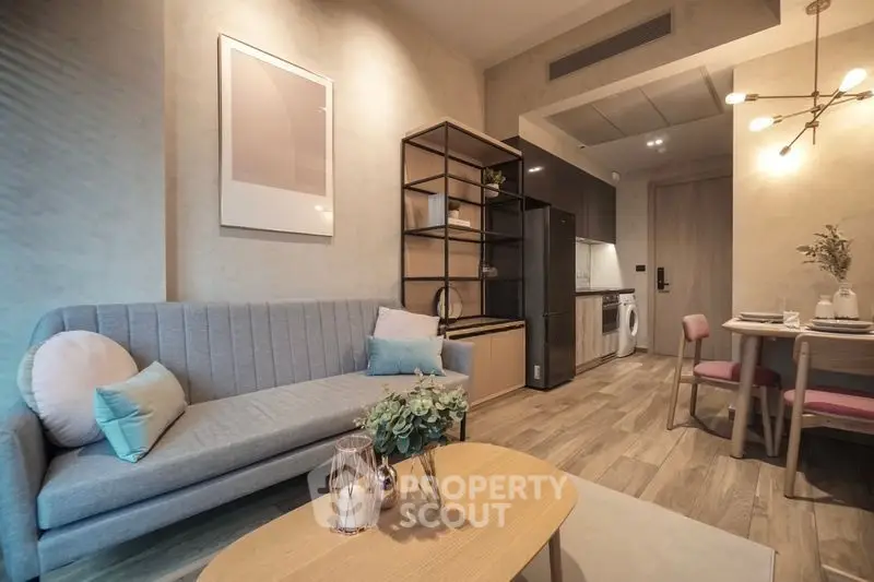 Modern living room with stylish decor and open layout, featuring a cozy sofa and dining area.