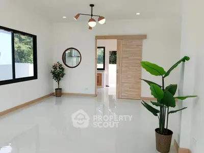 Spacious modern living room with large window and stylish decor