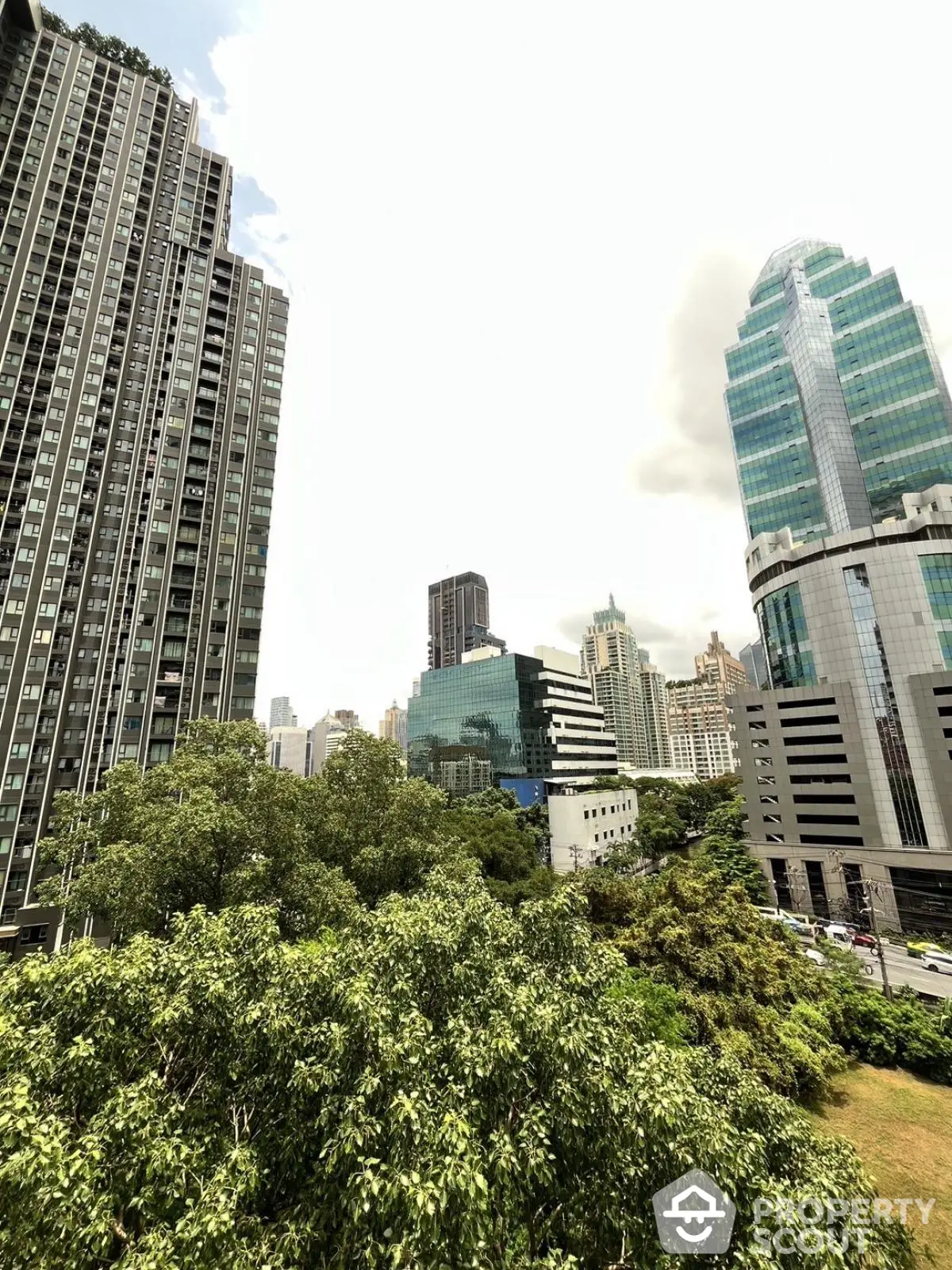 Stunning urban skyline view with modern skyscrapers and lush greenery, perfect for city living enthusiasts.