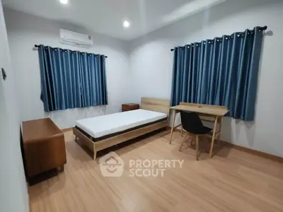 Modern minimalist bedroom with wooden furniture and blue curtains