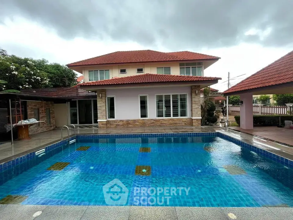 Stunning two-story home with a beautiful outdoor pool and spacious patio area.
