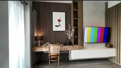 Modern study room with stylish decor and wall-mounted TV, featuring elegant wood paneling and contemporary furniture.