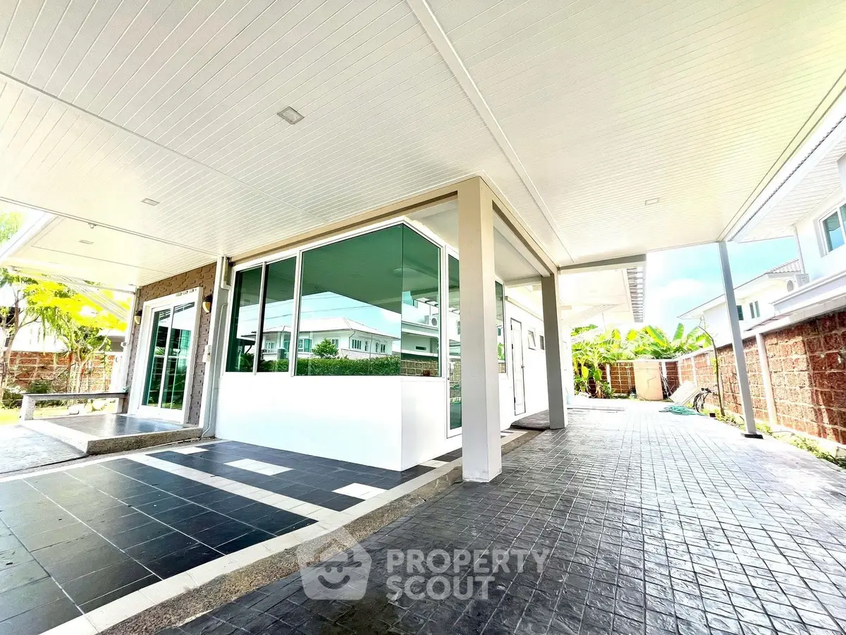 Spacious modern home exterior with sleek design and ample natural light.
