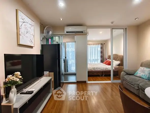 Modern living room with open layout, featuring a cozy bedroom and stylish decor.