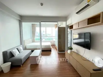 Modern living room with sleek design and natural light in a stylish apartment.