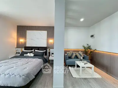 Modern bedroom with cozy seating area and stylish decor