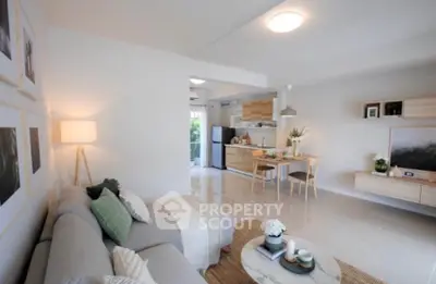 Modern open-plan living room with stylish decor and kitchen area