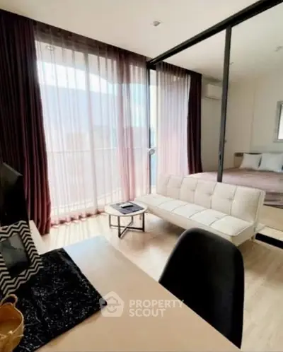 Modern studio apartment with glass partition and cozy decor