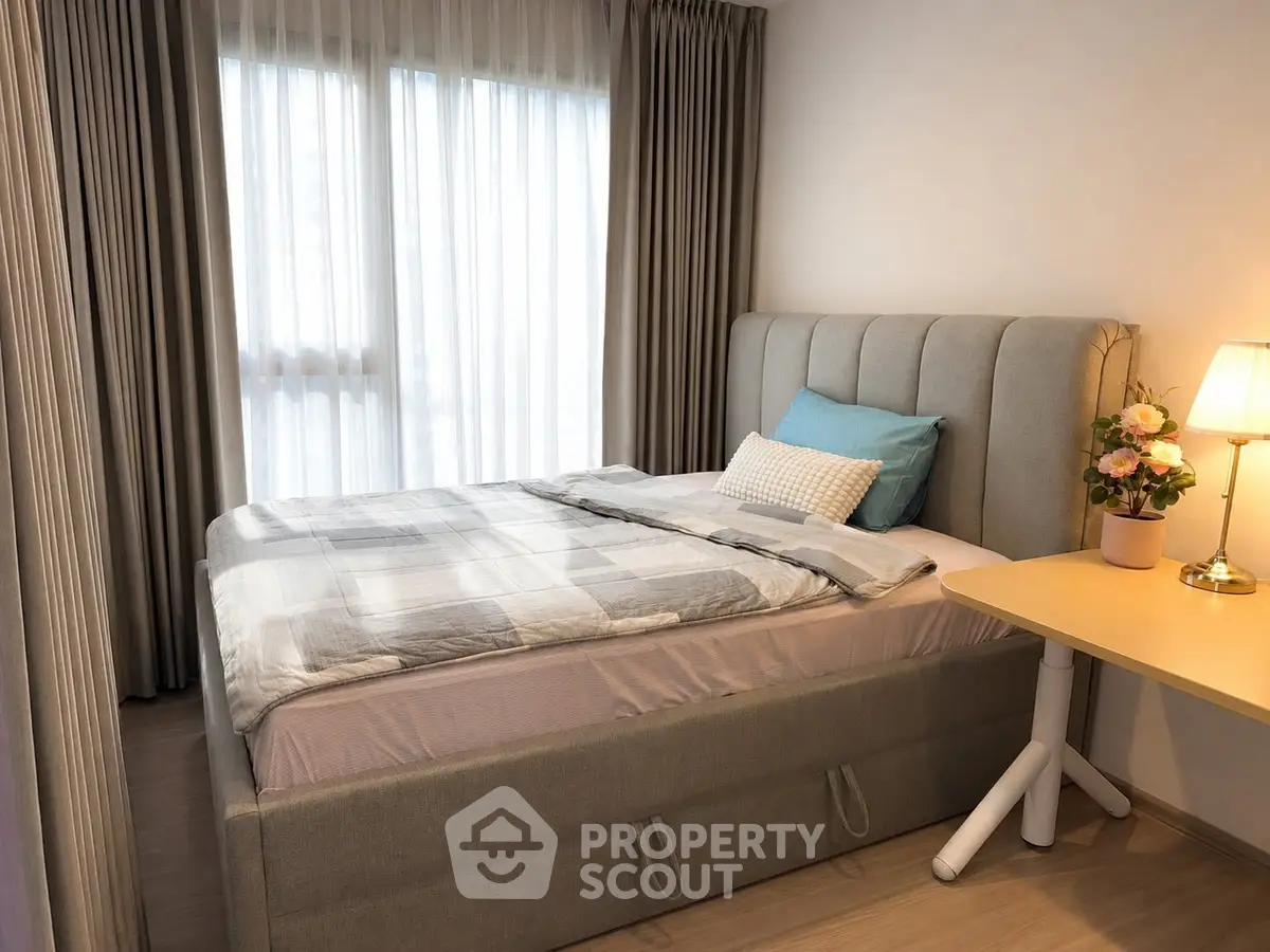 Cozy bedroom with stylish decor and natural light, perfect for relaxation and comfort.