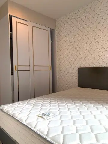 Modern bedroom with stylish closet and comfortable mattress in a chic apartment.