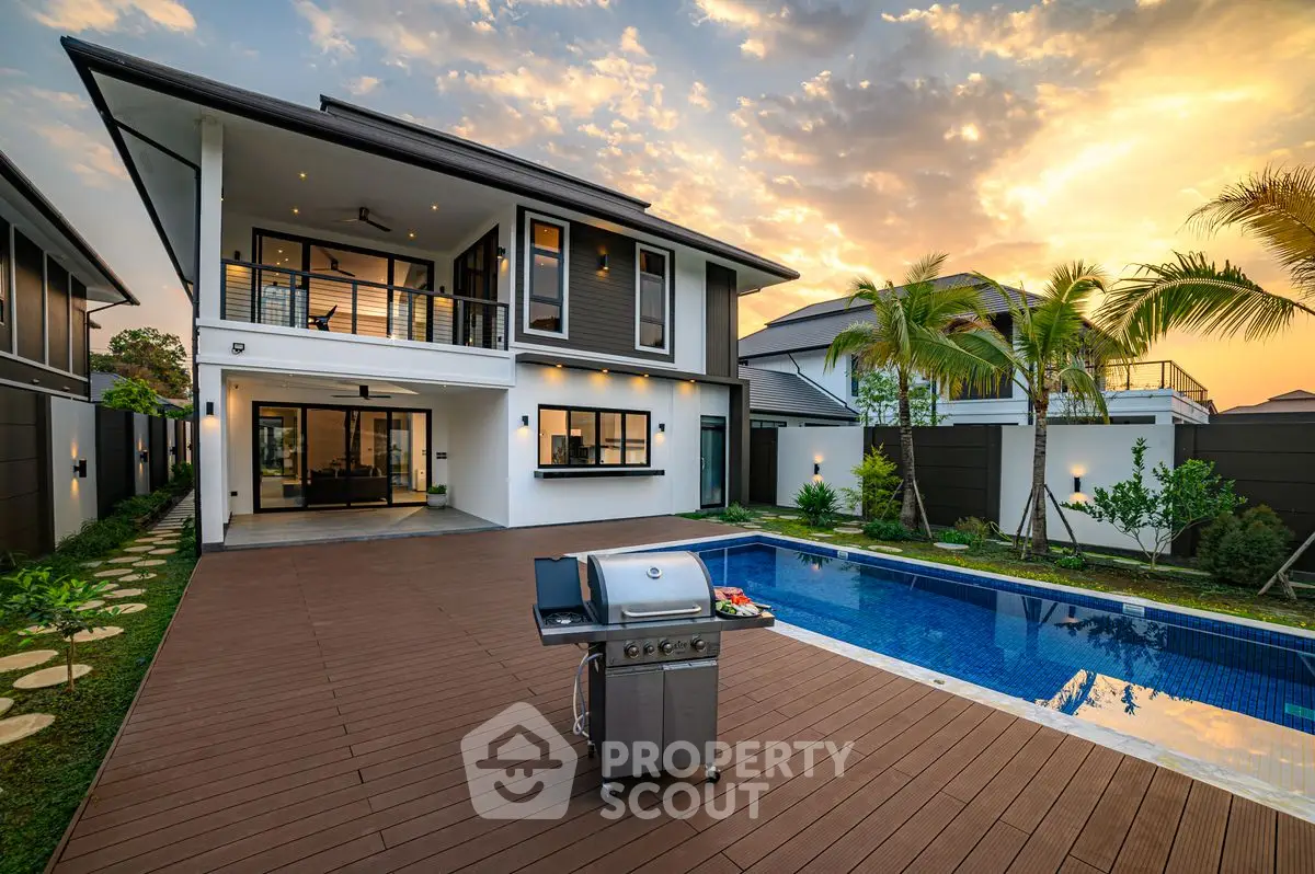 Luxurious modern home with pool and spacious deck at sunset, perfect for entertaining.
