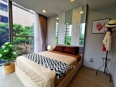 Modern bedroom with large windows and stylish decor in urban apartment