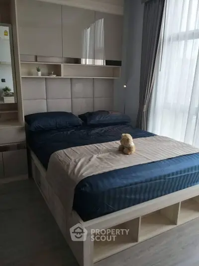 Cozy modern bedroom with plush bedding and ample natural light
