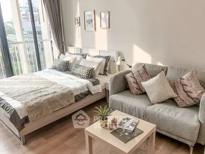 Chic bedroom with cozy seating area and large window view