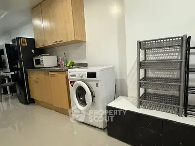 Modern kitchen with washing machine and ample storage space