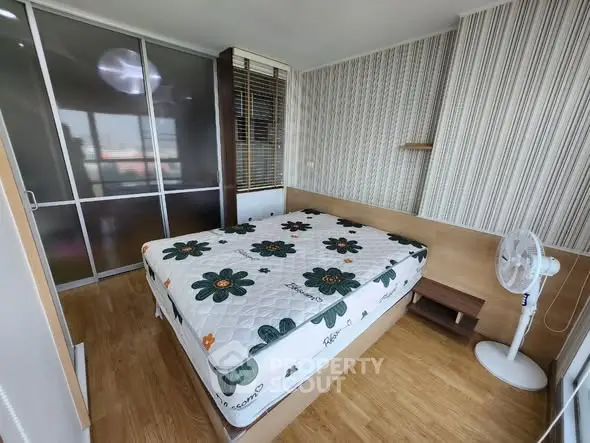 Cozy bedroom with floral mattress and sliding glass door wardrobe