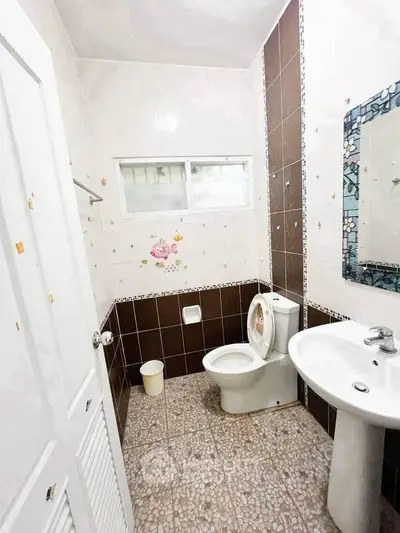Charming bathroom with modern fixtures and stylish tile design, perfect for a cozy home.