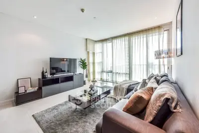 Spacious modern living room with large windows and stylish decor