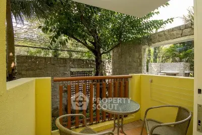 Charming small balcony with garden view, perfect for relaxing outdoors.