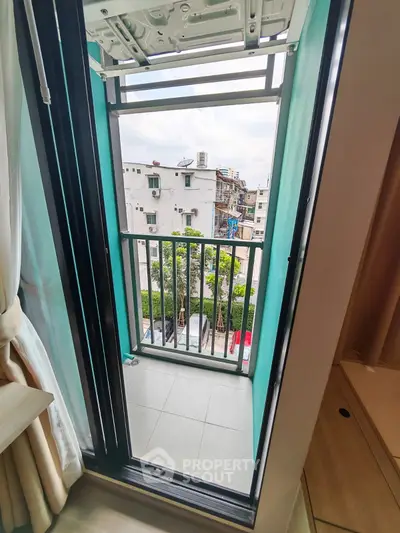 Charming small balcony with city view, perfect for relaxing and enjoying the outdoors.