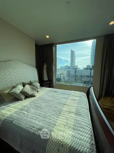 Luxurious bedroom with stunning city view from large window